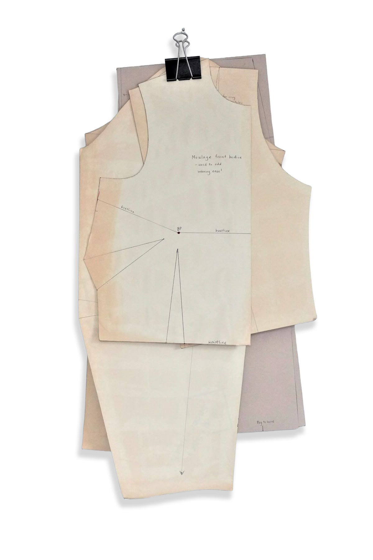 Layered paper garment pattern pieces with pencil annotations